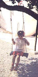 Swinging in the playground with a pupil from the Wonderworld Nursery school & Kindergarten in Larnaca, Cyprus 